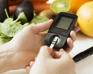 Diabetes monitor, diet and healthy food eating nutritional concept with clean fruits and vegetables with diabetic measuring tool kit
