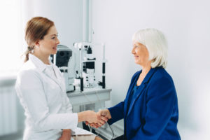 Handshake with a aged patient at optometrist office
