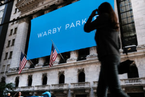 NEW YORK, NEW YORK - SEPTEMBER 29: People gather outside of the New York Stock Exchange (NYSE) as Warby Parker makes its debut via a direct listing on the stock market on September 29, 2021 in New York City. Following Tuesday's losses and a decline in technology stocks, markets gained ground Wednesday morning with both the Nasdaq and the Dow in positive territory. (Photo by Spencer Platt/Getty Images)
