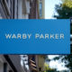 CHICAGO, ILLINOIS - SEPTEMBER 29: A sign marks the location of a Warby Parker store on September 29, 2021 in Chicago, Illinois. Warby Parker stock made its public debut today at $54.05-per-share, well above its $40 reference point. (Photo by Scott Olson/Getty Images)