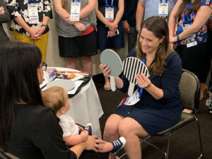 Dr. Zolman conducting an exam as part of the InfantSEE program, which her practice participates in. Dr. Zolman says early care for children is essential to their eye health and development and a great way to bring whole families of patients into the practice.