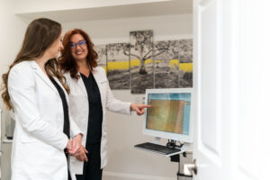 Dr. Hitchmoth with the Jessica Eid, OD, reviewing a diabetic patient's retinal scan. Dr. Hitchmoth says focusing on diabetes care reaps great rewards in patient care, and offers a way to expand your practice.